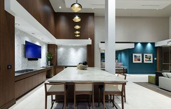 Resort-style pool deck with private cabanas, cozy fireplace, and grilling and dining areas